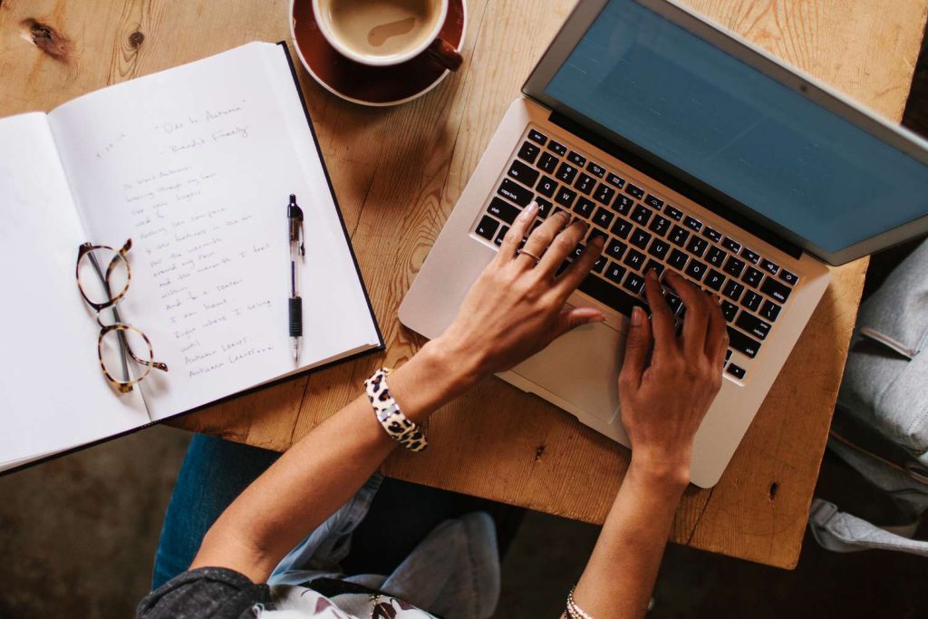woman typing on macbook